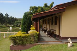 a group of benches sitting next to a building at Hotel Fazenda Santa Maria in Serra Negra