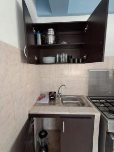 a kitchen with a sink and a stove at Villas Venecia in Maracay