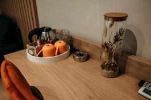 a wooden table with a counter top with a vase at Casa Dragan in Baile Felix