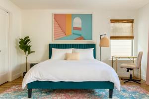 a bedroom with a large bed and a chair at Houston House - Free Parking in Houston