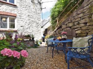 a blue table and chairs in a garden at 2 Bed in Brecon 92729 in Brecon +15 photos