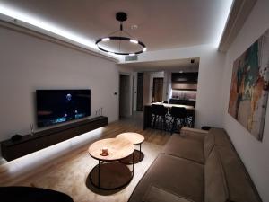 a living room with a couch and a table at Cevahir Sky View in Skopje
