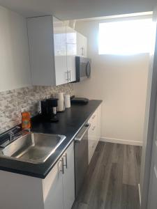 a kitchen with a sink and a counter top at Friendly Extended Stay and Comfort in Winnipeg