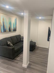 a living room with a couch and a wall at Friendly Extended Stay and Comfort in Winnipeg