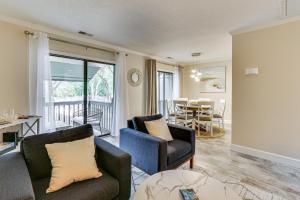 a living room with two chairs and a table at Walk to Folly Field Beach Condo with Pool Access in Hilton Head Island