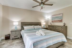 a bedroom with a large bed with two night stands at Walk to Folly Field Beach Condo with Pool Access in Hilton Head Island +18 photos