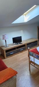 a living room with a flat screen tv on a table at Noclegi u Lili in Człuchów +24 photos