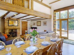 a dining room with a wooden table and chairs at 4 Bed in Cowes 88913 in Porchfield