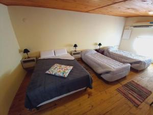 a bedroom with two beds in a room at Dpto Centro in Las Flores