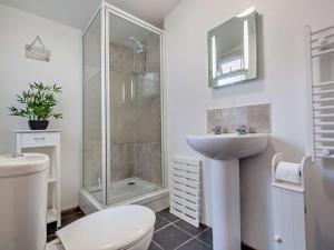 a bathroom with a shower and a toilet and a sink at 2 Bed in Nefyn 92561 in Llithfaen +14 photos