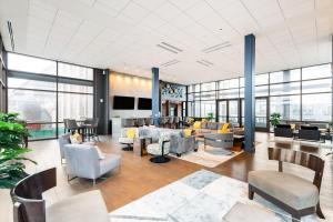 an office lobby with a lot of furniture and windows at 2B 2BA Luxury Downtown Suite Rooftop Deck & Gym in Baltimore