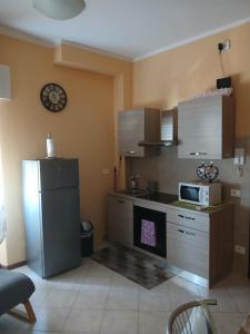 a kitchen with a refrigerator and a microwave at La Torretta Sul Porto - Parcheggio gratuito in Livorno +27 photos