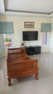 a living room with a bench and a flat screen tv at Private Garden Villa Koh Lanta in Phra Ae beach +60 photos