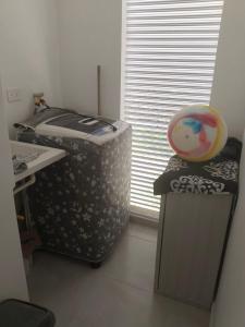a room with a desk and a large window at Apartamento en melgar tolima in Melgar