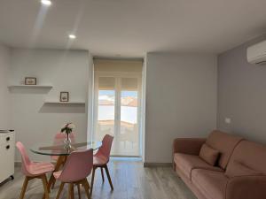 a living room with a table and a couch at Hotel Apartamentos Antequera in Antequera
