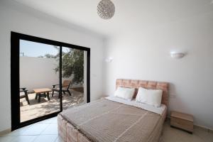 Ένα ή περισσότερα κρεβάτια σε δωμάτιο στο Villa Elnaya Midoun sans vis à vis +17 φωτογραφίες