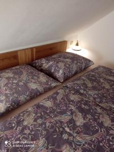 a bedroom with two beds with purple sheets at Pension Fanlor in Zubčická Lhotka +53 photos