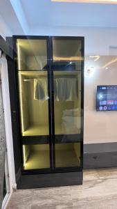 a black refrigerator with its door open in a room at Isha Homes in Greater Noida