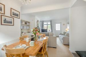 a kitchen and living room with a wooden table at Ivy Cottage in Thurgarton