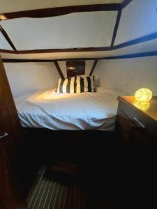 a bed in a small room in a boat at 43' Classic Trawler 5 Star Resort Pools, Views, Dining Free Shuttle to Downtown in Stock Island +8 photos