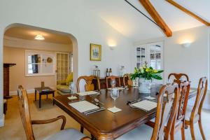 a dining room with a wooden table and chairs at Rose Cottage - West Runton in West Runton