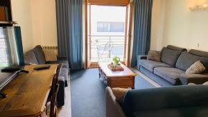 a living room with a couch and a table at Superb flat in the centre of capital, ski, Caldea in Andorra la Vella