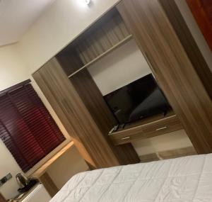 a bedroom with a door with a window and a bed at HABITAT APARTMENTs in Calabar