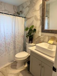 a white bathroom with a toilet and a sink at Family home with big backyard in New Port Richey in New Port Richey