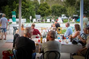 a group of people sitting at a table eating at Agriturismo Orto Arcobaleno in Zelarino