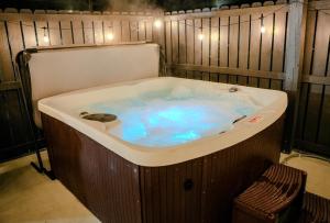 a jacuzzi tub in a room with lights at Whiskey Trails Getaway in McMinnville