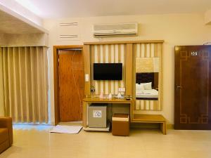 a living room with a desk and a television at Hotel Beach Way in Cox's Bazar +29 photos