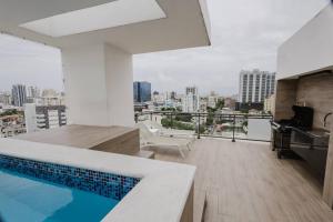 a bathroom with a swimming pool on top of a building at Stylish, City Center 2BD Condo in Carlos Guerra