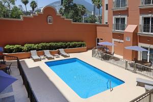 a swimming pool on the roof of a building at Holiday Inn Express Monterrey Galerias-San Jeronimo by IHG in Monterrey
