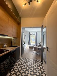 a kitchen with a sink and a table at Apartment Ceasul Electric in Satu Mare