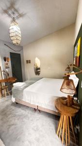 a bedroom with a large bed and a table at Kitnet Sertão na Ilha do Ferro AL in Pão de Açúcar