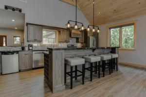 a kitchen with a large island with bar stools at Waterfront 3 Bedroom Home in Port McNicoll