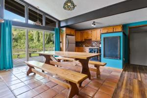 a dining room with a table and benches at Stunning Mountain Getaway with Open Concept Design in Blue Mountains