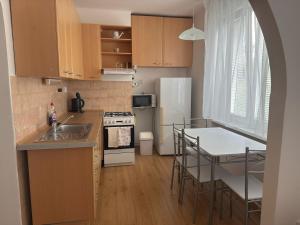 a kitchen with a sink and a stove top oven at Harmony apartment in Šamorín