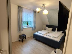 a small bedroom with a bed and a window at Klütz Semi-Detached House, 2 Double Beds, 2 Single Beds in Klütz