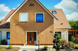 a brown house with a brown roof at Klütz Semi-Detached House, 2 Double Beds, 2 Single Beds in Klütz
