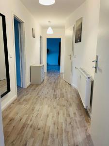 an empty room with wooden floors and a hallway at Viechelner Chaussee 6, 4 Single Beds in Bad Kleinen