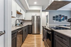 a kitchen with a stainless steel refrigerator at Perfect Frisco Work Relax Suite in Frisco