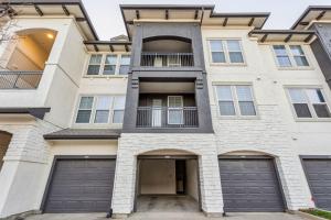 an apartment building with two garage doors at Perfect Frisco Work Relax Suite in Frisco