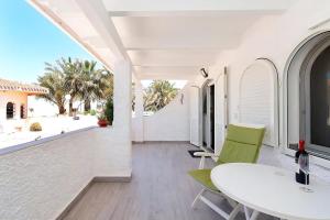 eine Terrasse mit einem weißen Tisch und Stühlen und einem Fenster in der Unterkunft Wunderschöne Wohnung in Cartagena mit Gemeinschafts Pool und Terrasse in Los Urrutias