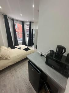 a bedroom with a bed and a television in it at Clapham Junction moments away in London