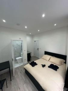 a bedroom with a large bed and a bathroom at Clapham Junction moments away in London