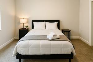 a bedroom with a large white bed with two tables at Stylish Luxe Suite Rock Hall, Stadiums, Casino in Cleveland +20 photos