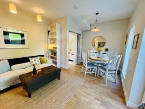 a living room with a couch and a table at Chic Welsh Escape Character Home in Newport