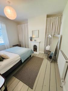 a bedroom with a bed and a fireplace at Chic Welsh Escape Character Home in Newport