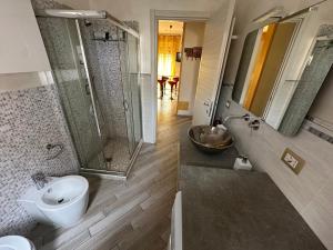 a bathroom with a shower and a toilet and a sink at La Concordia in Novi Ligure